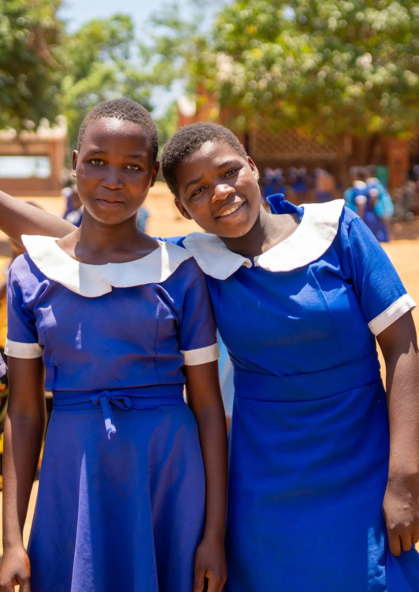 Two Malawian schoolgirls in blue uniforms